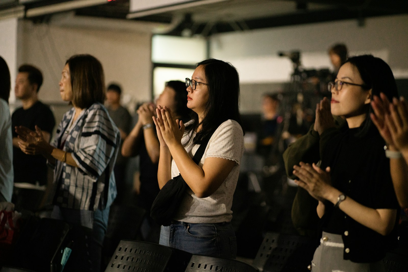 Women standing and applauding at an event